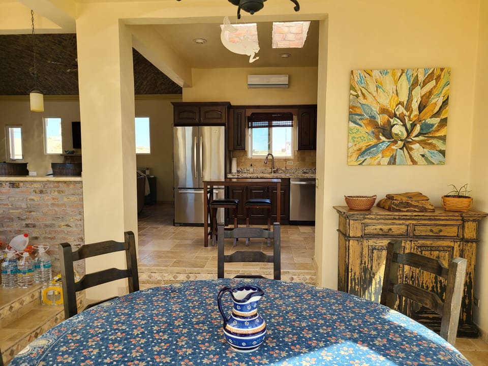 Dining room faces courtyard, kitchen, living room, and bar.