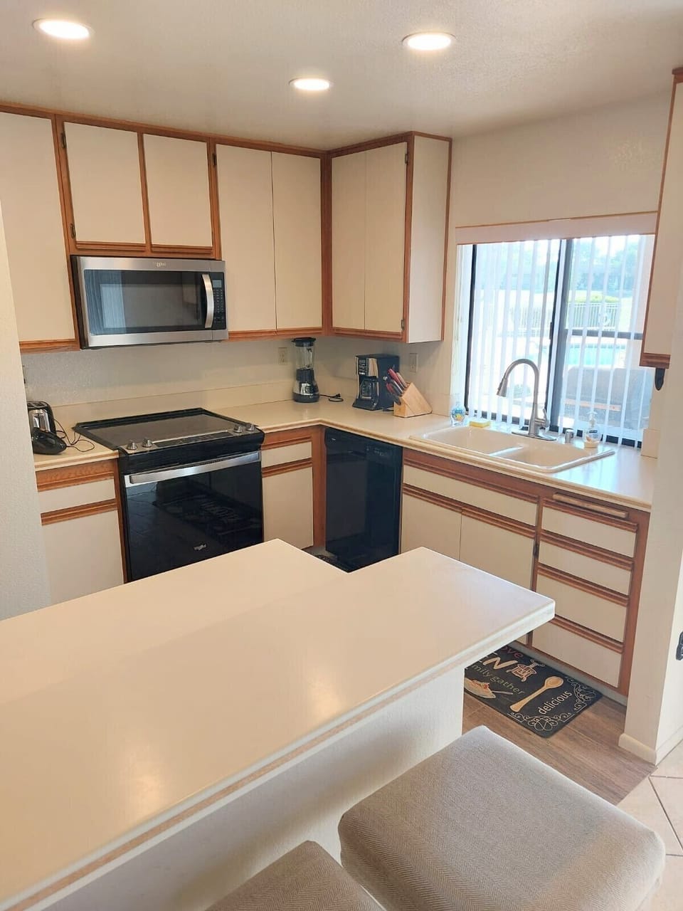 Upgraded kitchen with new appliances, lighting & flooring