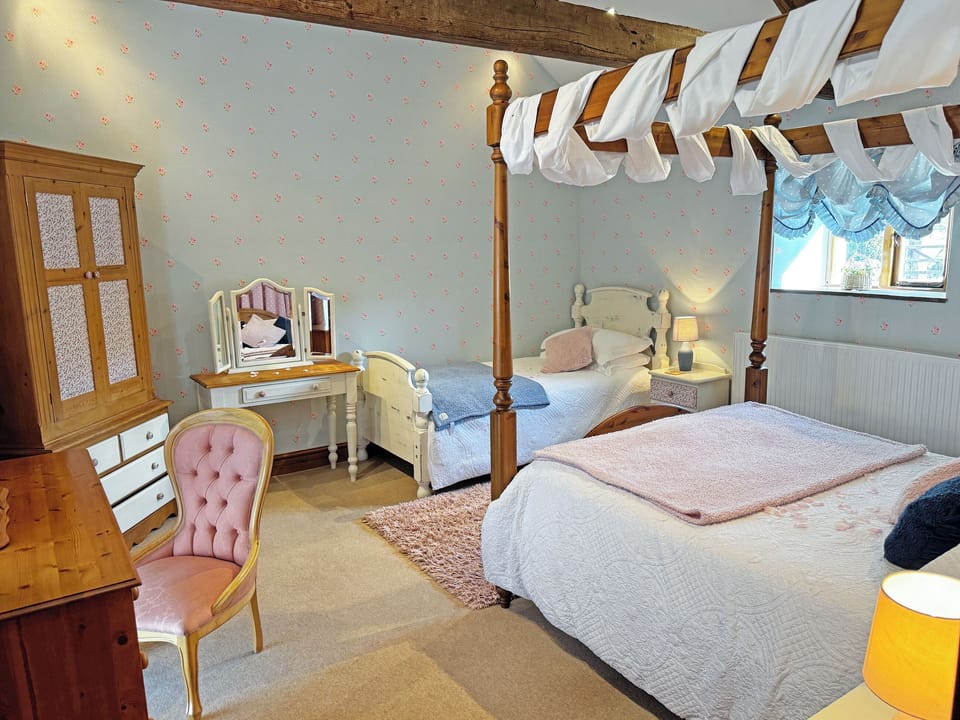 Family bedroom includes one kingsize four poster and one single bed | Lily Rose Cottage, Gilsland, near Brampton