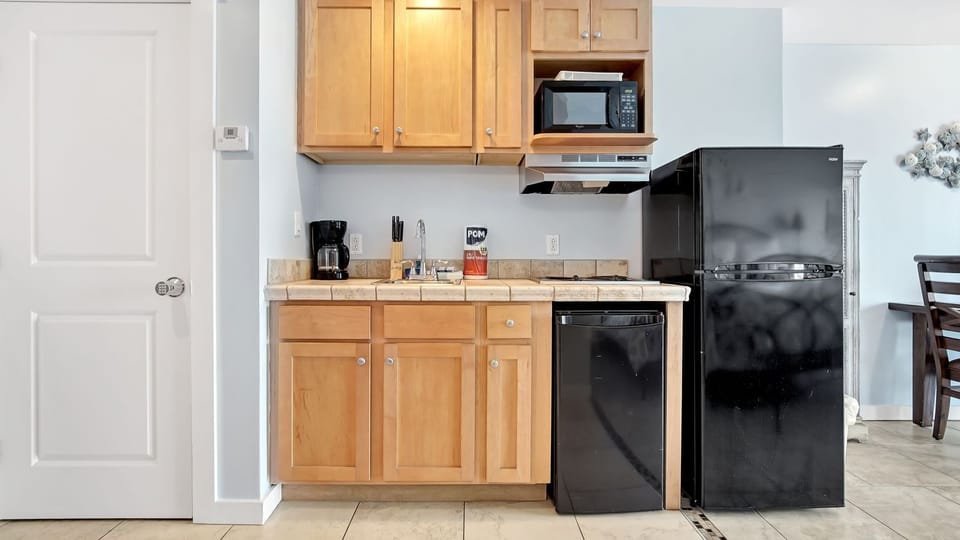 Everything you'll need to make some quick meals including a microwave, stove top, knife set, & cooking + eating utensils!