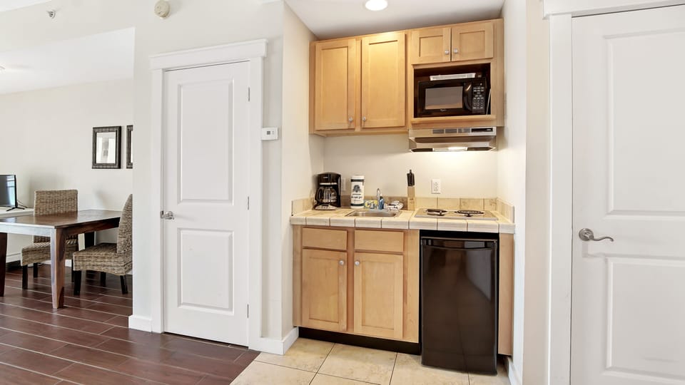 Everything you will need to make some quick meals including a microwave, stove top, coffee pot, cooking + eating utensils!