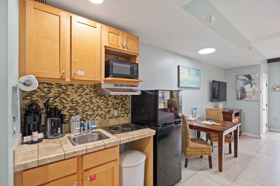 Kitchenette with dorm fridge and two burner stove. K-cup coffee maker and a microwave for small meals.