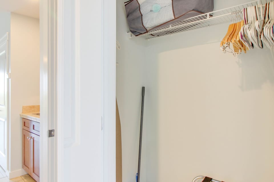 Good size closet with a luggage rack + iron/ironing board + hangers + broom & dustpan!