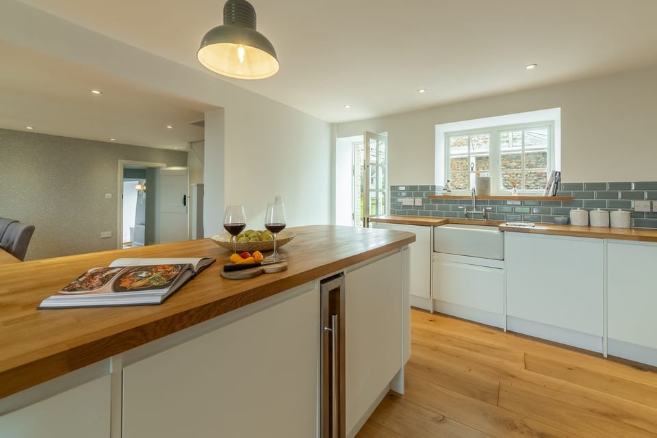 Ground floor: Kitchen showing back door and a peek in to open-plan dining area