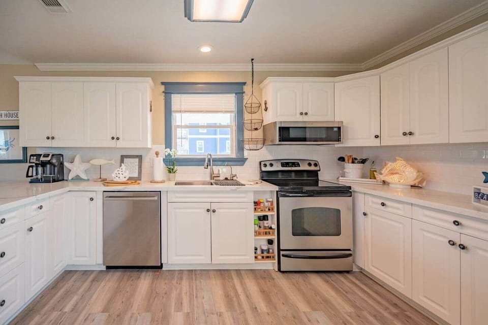 The kitchen is stocked bowls, pans, pots, platters, baking dishes, knives, serving-wear and more