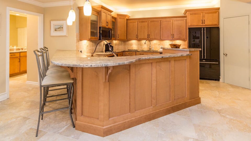 Another view of the kitchen with large refrigerator