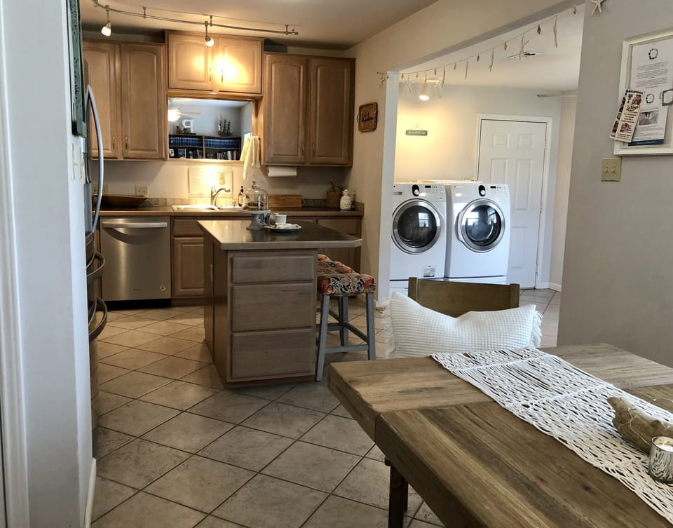 The open concept kitchen, dinnerware and basic cooking essentials are provided.