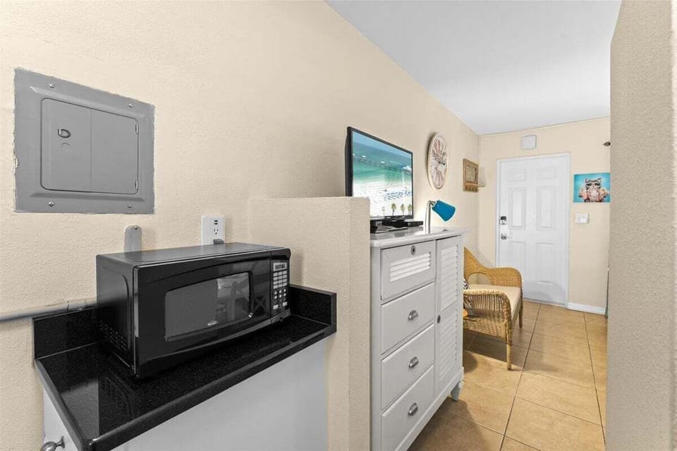 Compact kitchenette with a stove, fridge, microwave, coffee maker, and dedicated mini-split AC — everything you need for easy meals during your stay.