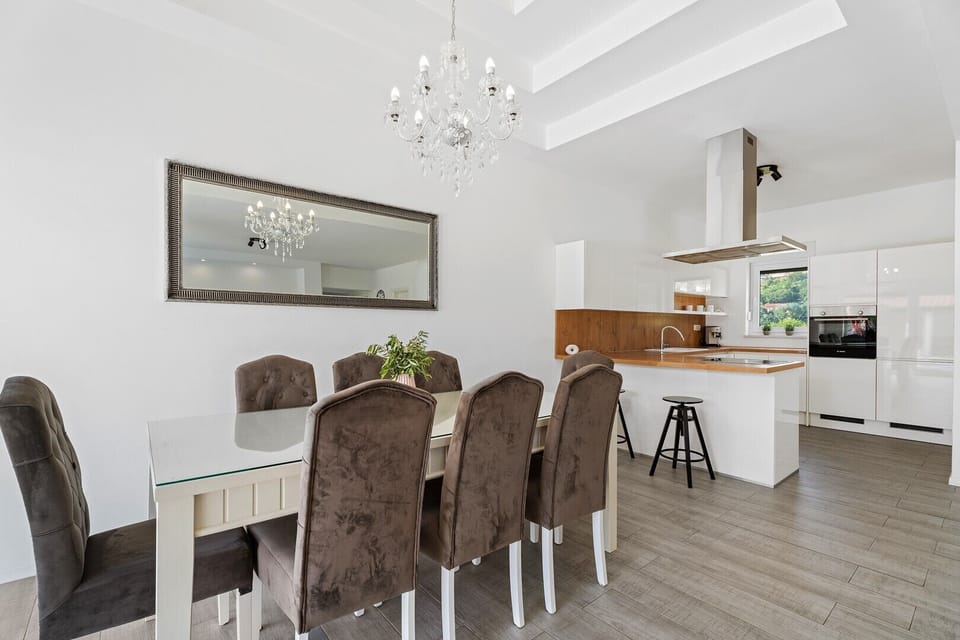 A dining area for 8 people, fully equipped kitchen