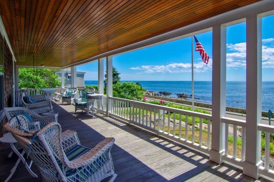 Large, wide porch with multiple seating and eating areas
