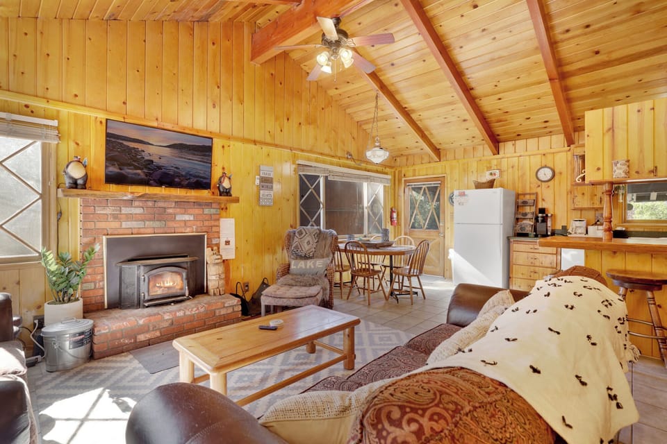 Bright open layout featuring a cozy living room, wood stove, and connected kitchen—great for spending time together.