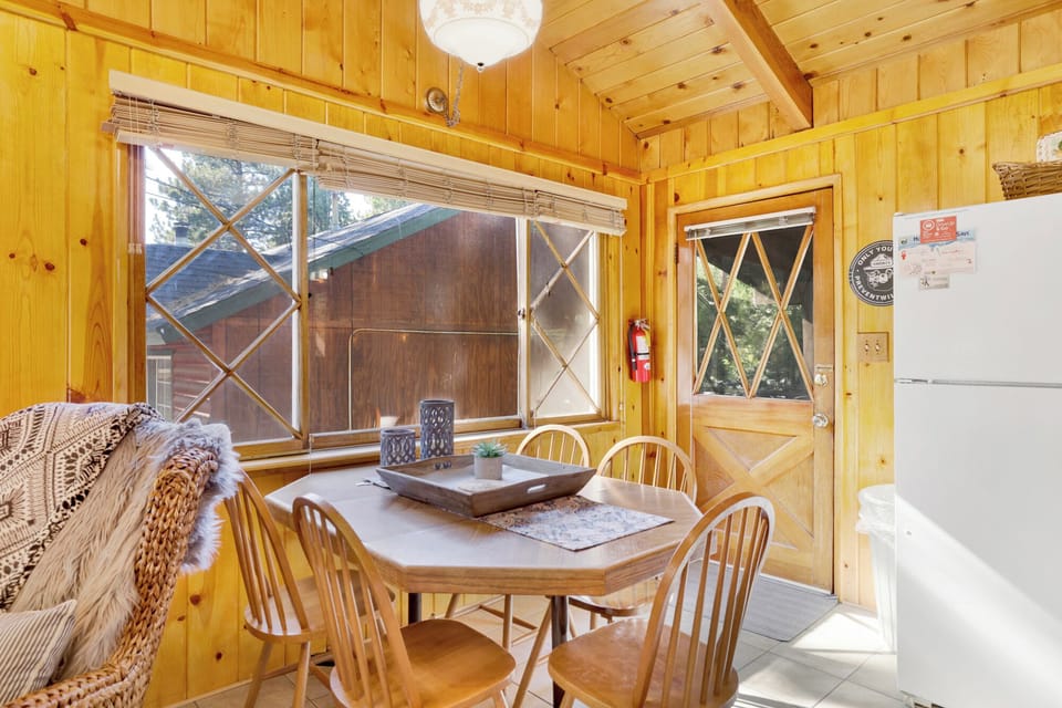 Cozy dining space with natural light great for shared meals, game nights, or planning your next Big Bear adventure.