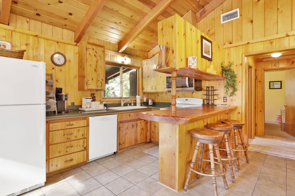 Open kitchen with bar seating and everything you need to cook meals at home great for families, couples, and long stays.