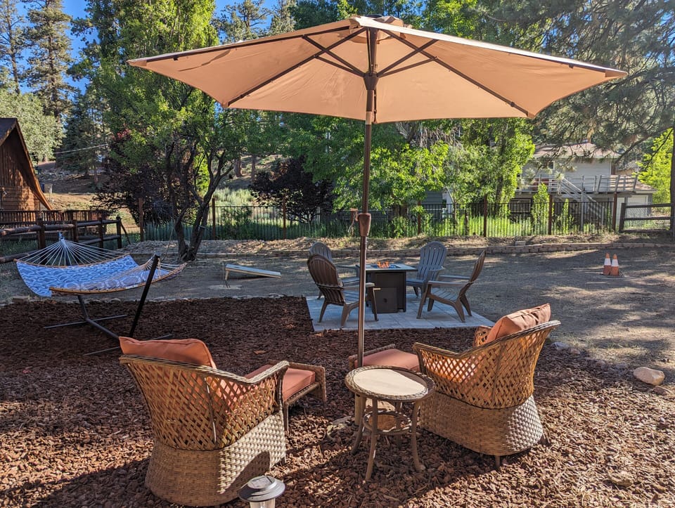 Enjoy the outdoor lounge area with seating and shade great for coffee, conversation, and relaxing under the trees.