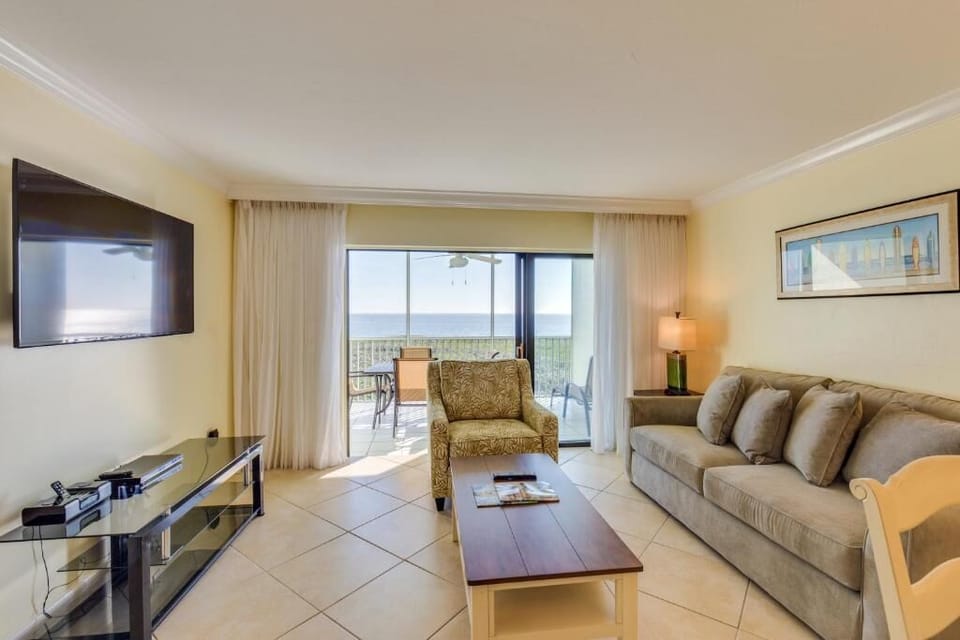 Unwind in crisp linens under a breezy, coastal ceiling fan