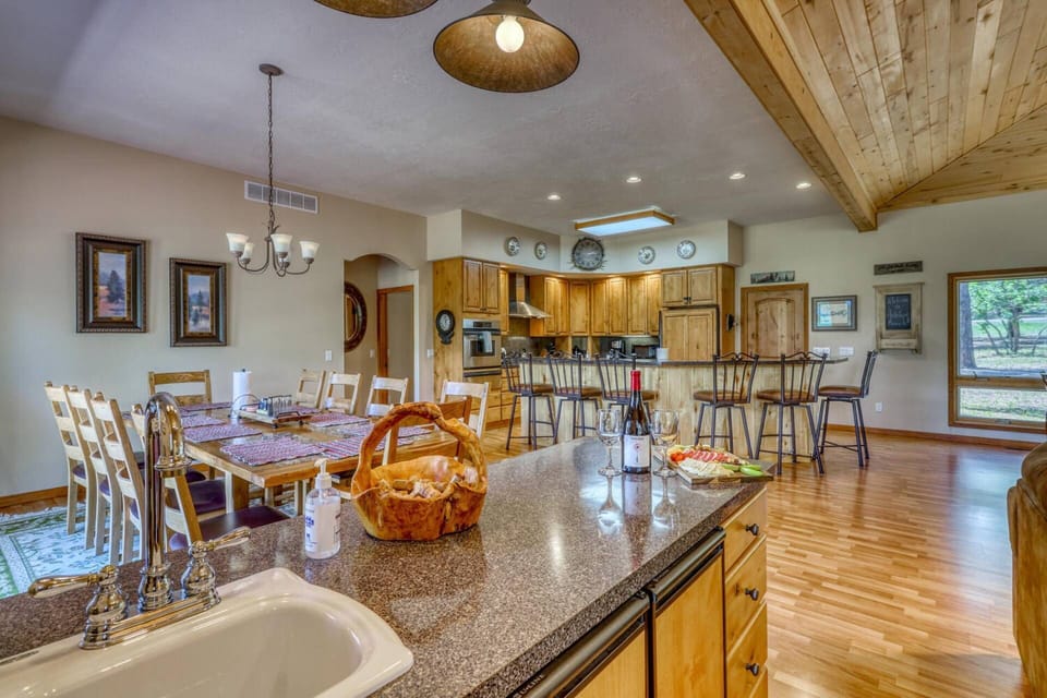 Fully equipped kitchen and fun wet bar and dining room complete the open concept family living space on the main floor with undeniable views.
