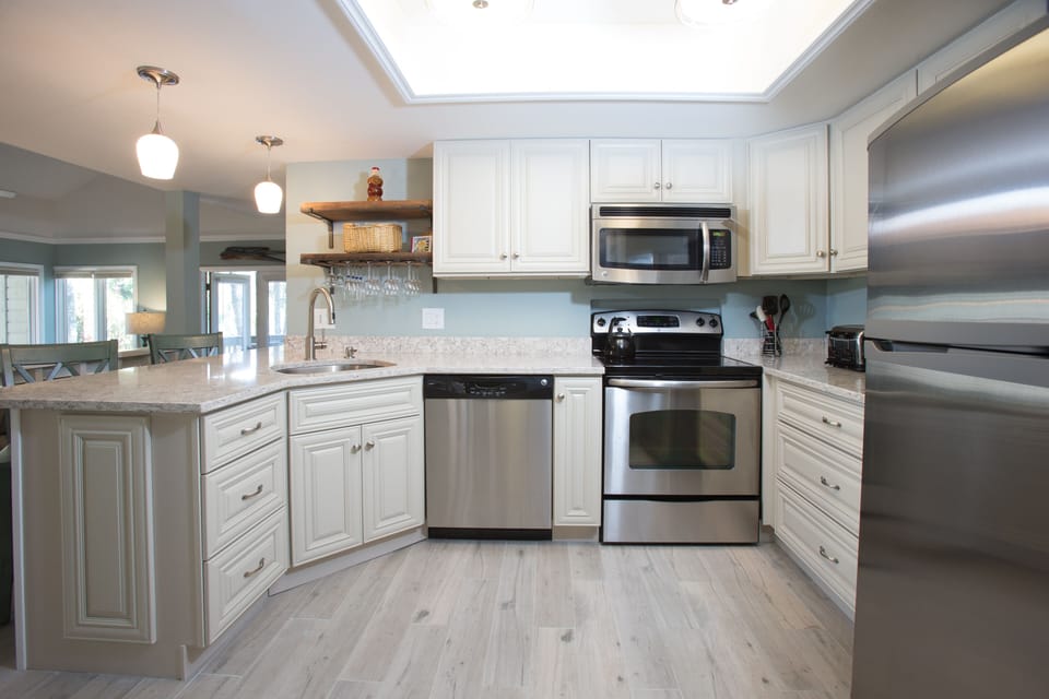 This open kitchen and breakfast bar create an easy, welcoming hub for everyday living and entertaining.