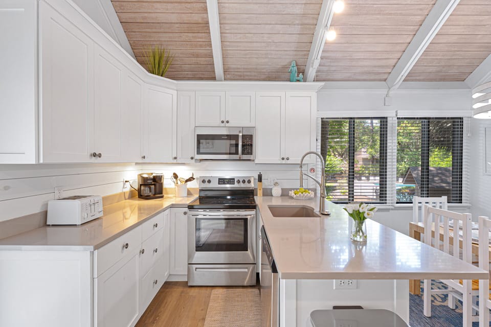 Stainless-steel appliances and a spacious peninsula with pull-up seating make meal prep effortless.