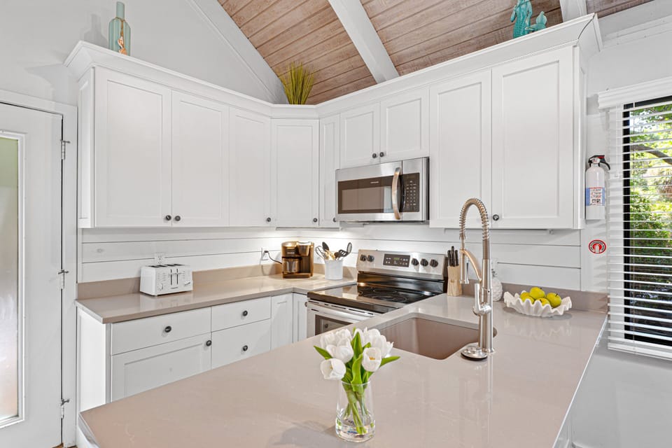 Stainless-steel appliances and a spacious peninsula with pull-up seating make meal prep effortless.