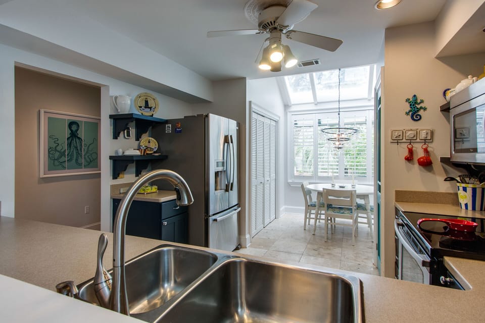Natural light pours in from the adjacent breakfast nook, enhanced by large windows and a skylight that create an airy, cheerful atmosphere.