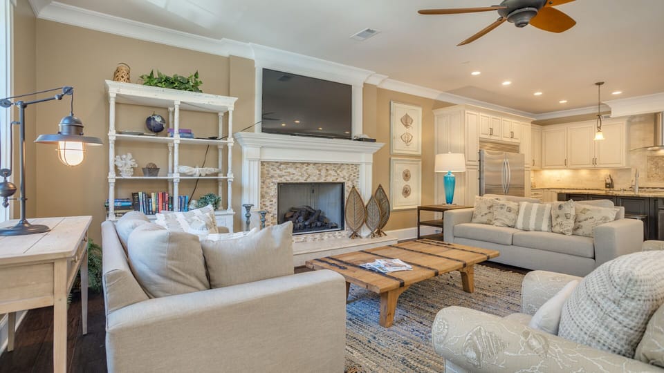 A beautiful fireplace with a custom tile surround serves as the focal point, paired with built-in shelving for books and décor.