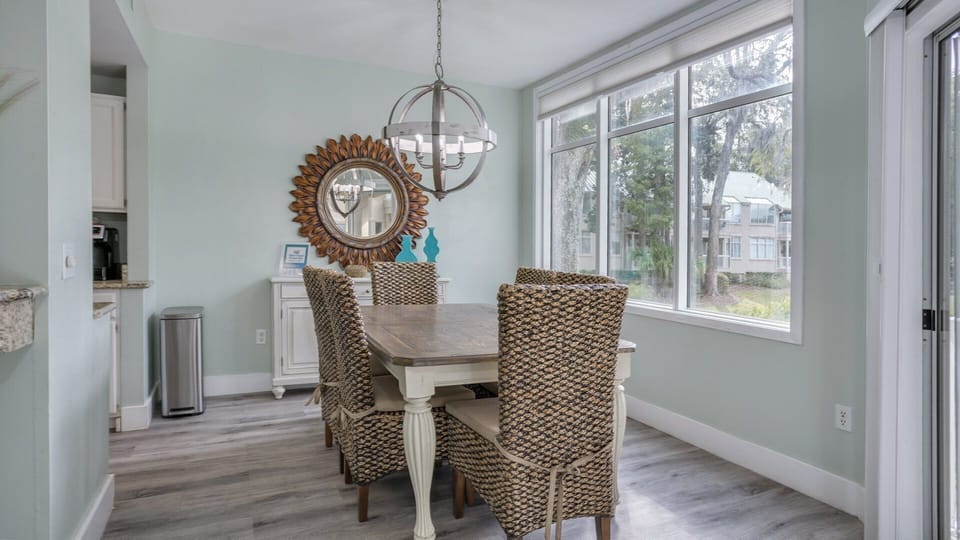 This inviting open-concept dining and living area is designed for easy coastal living.
