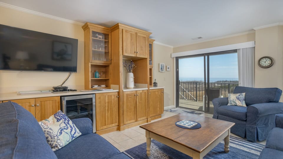 Large sliding glass doors open to a private balcony, bringing in natural light and extending the living space outdoors.
