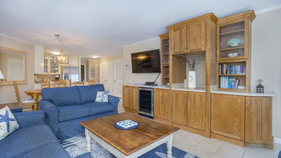 A media console and wall-mounted TV create an easy gathering spot after a day at the beach.