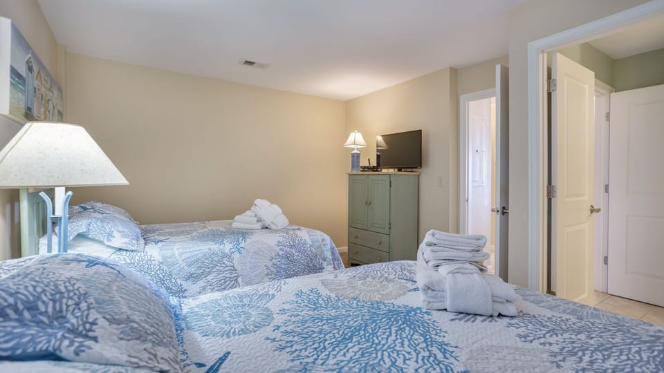 Soft coastal hues, updated flooring, and ample closet space create a bright, welcoming retreat.