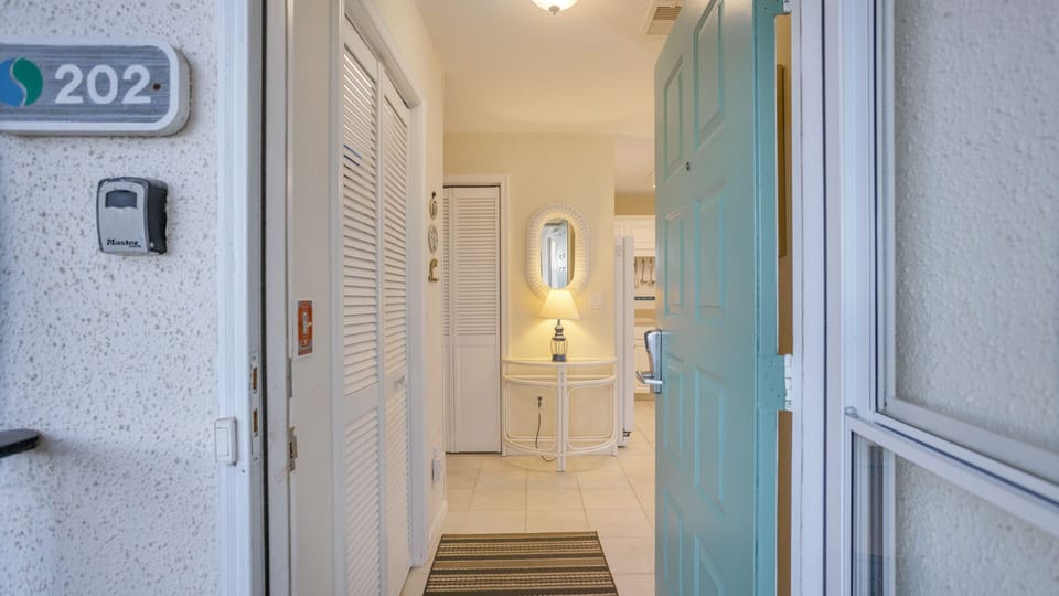 A welcoming entry sets the tone as you step inside, featuring a tiled foyer with soft coastal colors and classic finishes.