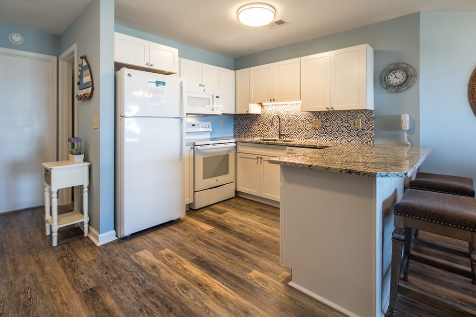 This bright, functional kitchen offers ample cabinet storage, a full suite of appliances and a generous peninsula that expands your seating and prep space.