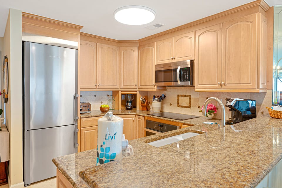 The beautifully updated kitchen combines timeless finishes with modern convenience, creating a space that's as functional as it is inviting.