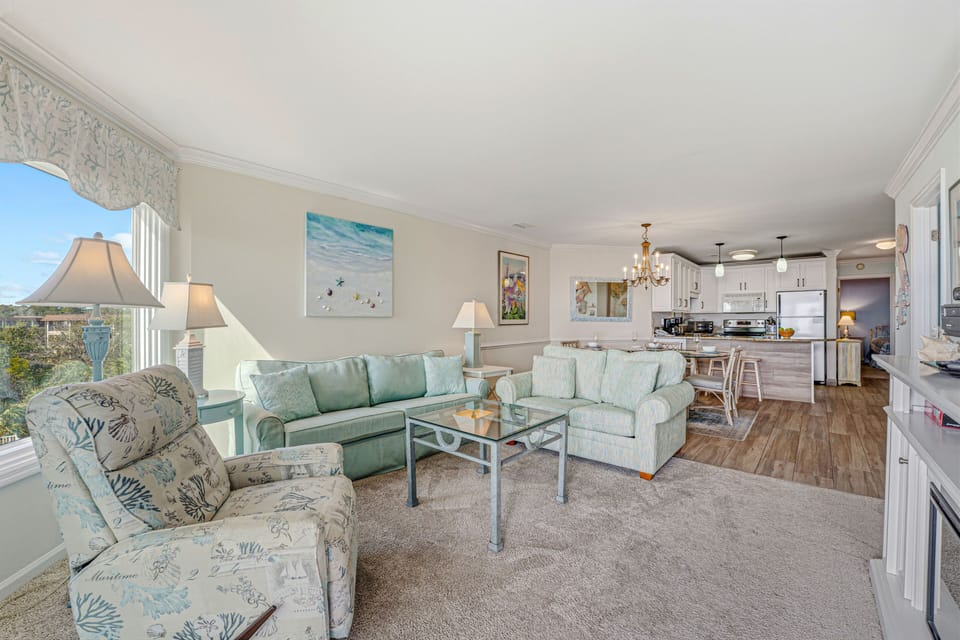Open and inviting living area with comfortable seating and easy flow into the dining space and kitchen.