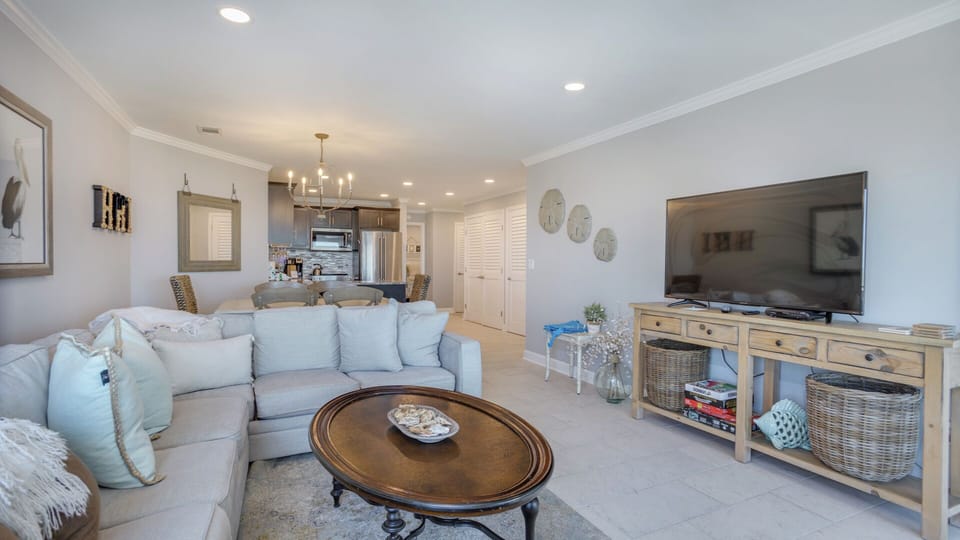 This open-concept living area offers a relaxed coastal feel with plenty of room to gather.
