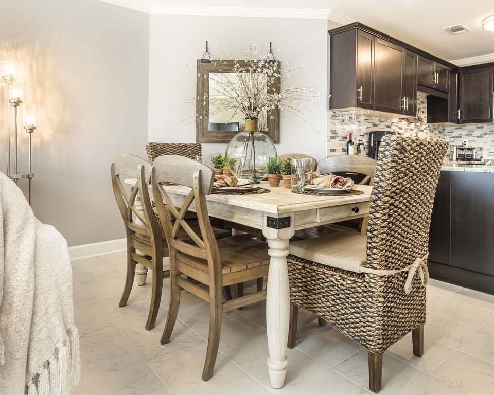 This inviting dining area is designed for easy meals and relaxed gatherings. The rustic table and comfortable seating create a warm, coastal feel.