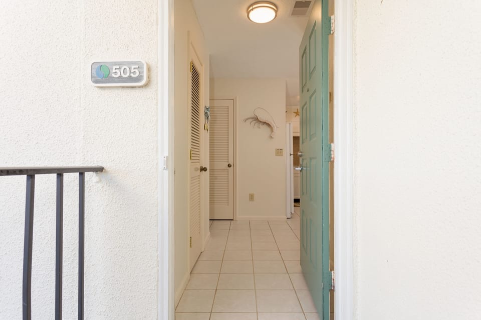 A welcoming entry sets the tone as you step inside, featuring a tile floor foyer with soft coastal colors and classic finishes.