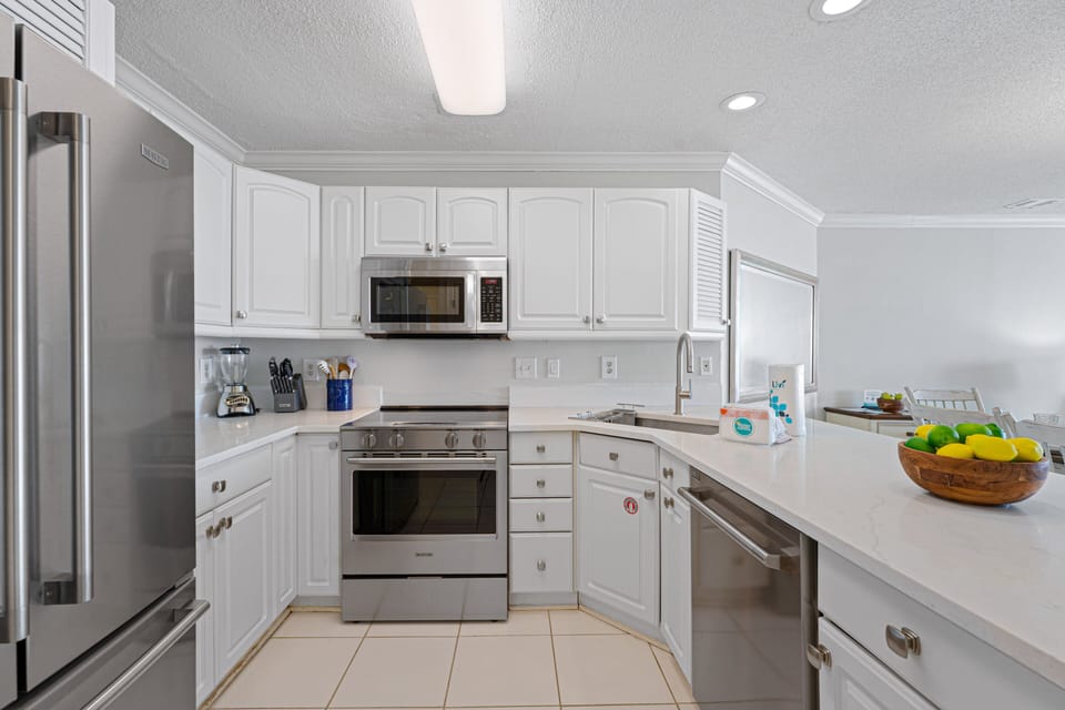This bright, functional kitchen offers ample cabinet storage, a full suite of appliances and a generous peninsula that expands your prep space.