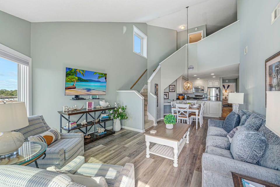Open and inviting living area with comfortable seating and easy flow into the dining space and kitchen.