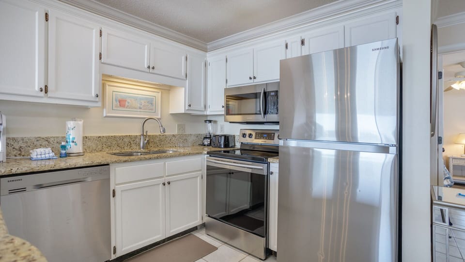 This bright, open kitchen offers generous counter space, granite surfaces, and ample cabinet storage—ideal for easy meal prep and entertaining.