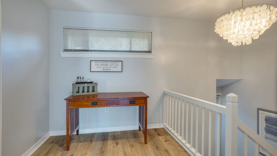 A desk nook creates a flexible space for a home office, planning station, or reading area, while the open railing keeps the area light and connected to the main living space below.