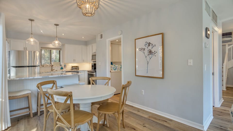 Bright and inviting, this updated dining area flows seamlessly into the kitchen, creating an ideal space for gathering and entertaining.