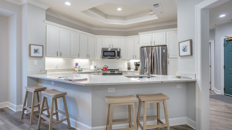 This bright, functional kitchen offers ample cabinet storage, a full suite of appliances and a generous bar that expands your seating.