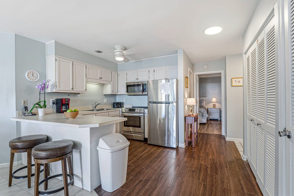 Open kitchen with stainless appliances, generous counter space, and a convenient breakfast bar for casual seating.