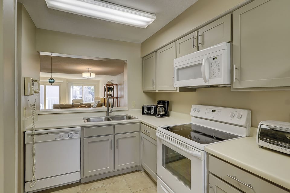 Ample counter space, and a functional layout make meal prep effortless, while the raised bar offers casual seating for morning coffee or quick bites.