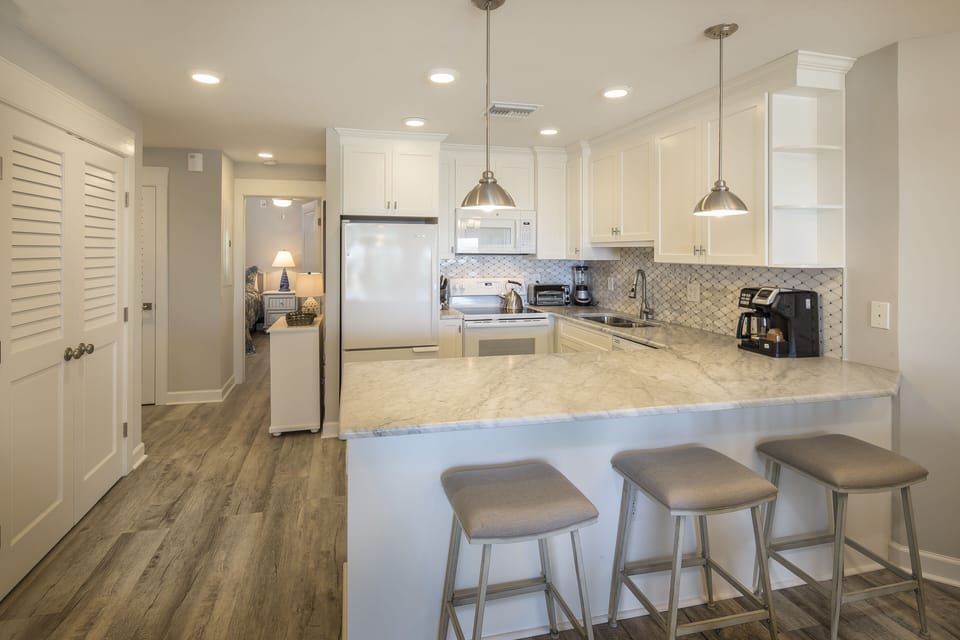 The breakfast bar with seating for two makes mornings easy, while the open layout keeps everyone connected during meal prep and gatherings.