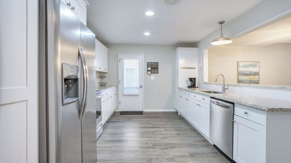 The clean subway-tile backsplash and generous counter space add a polished feel.