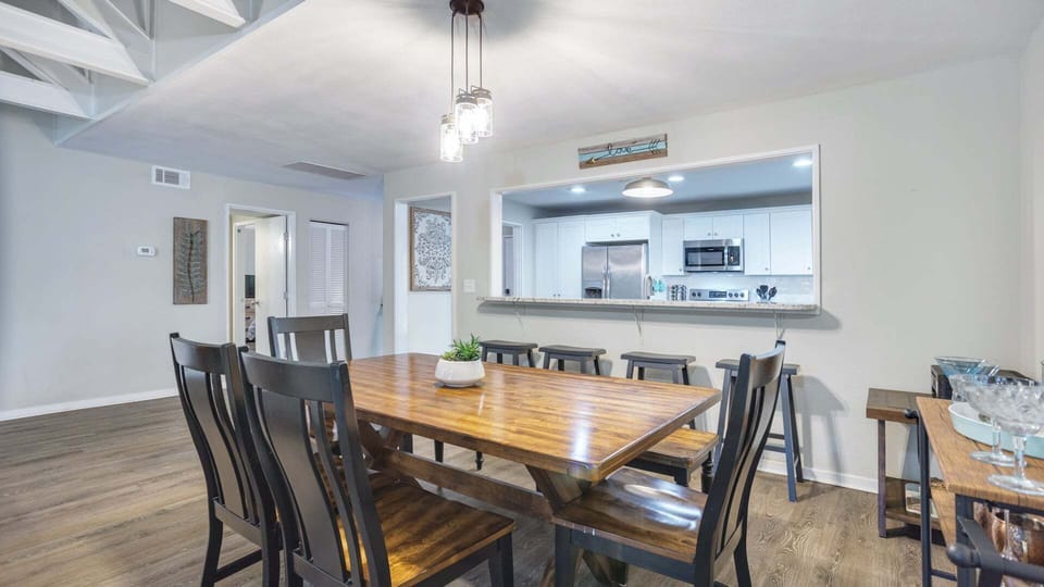 Gather around this warm, inviting dining area featuring comfortable seating for 6, soft lighting, and a clean, stylish setup. Perfect for family meals, game nights, or enjoying a relaxed dinner at home.