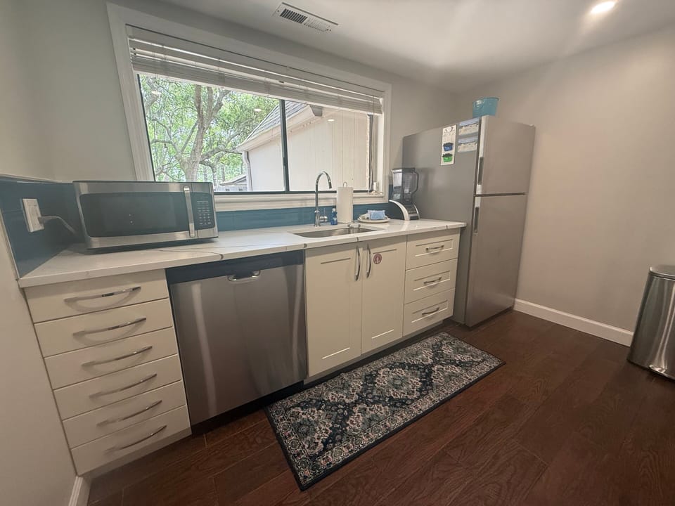 The window over the sink brings in natural light and a pleasant wooded view.