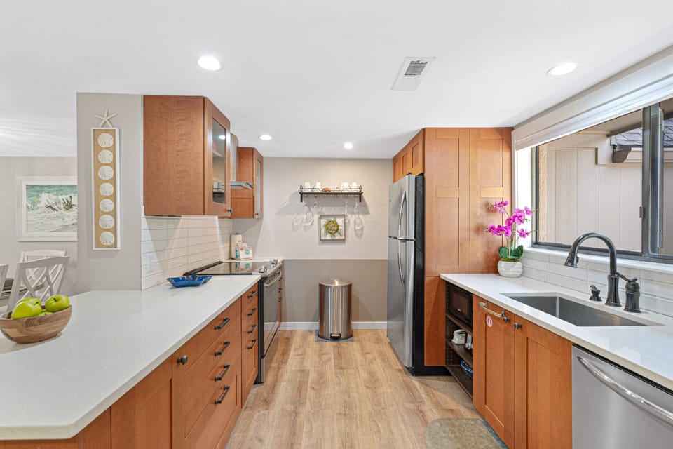 The updated kitchen has been thoughtfully renovated with modern finishes and a functional layout that makes meal preparation easy.