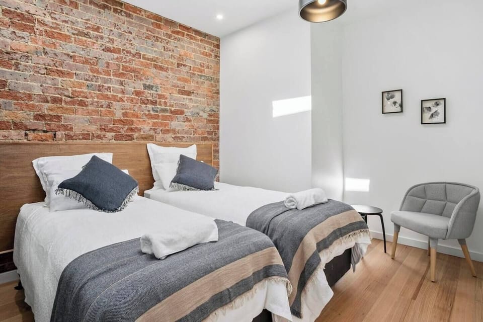 The second bedroom offers flexibility with two single beds, ideal for accommodating guests or family members. The room is tastefully designed with comfort in mind, ensuring everyone enjoys a peaceful stay.